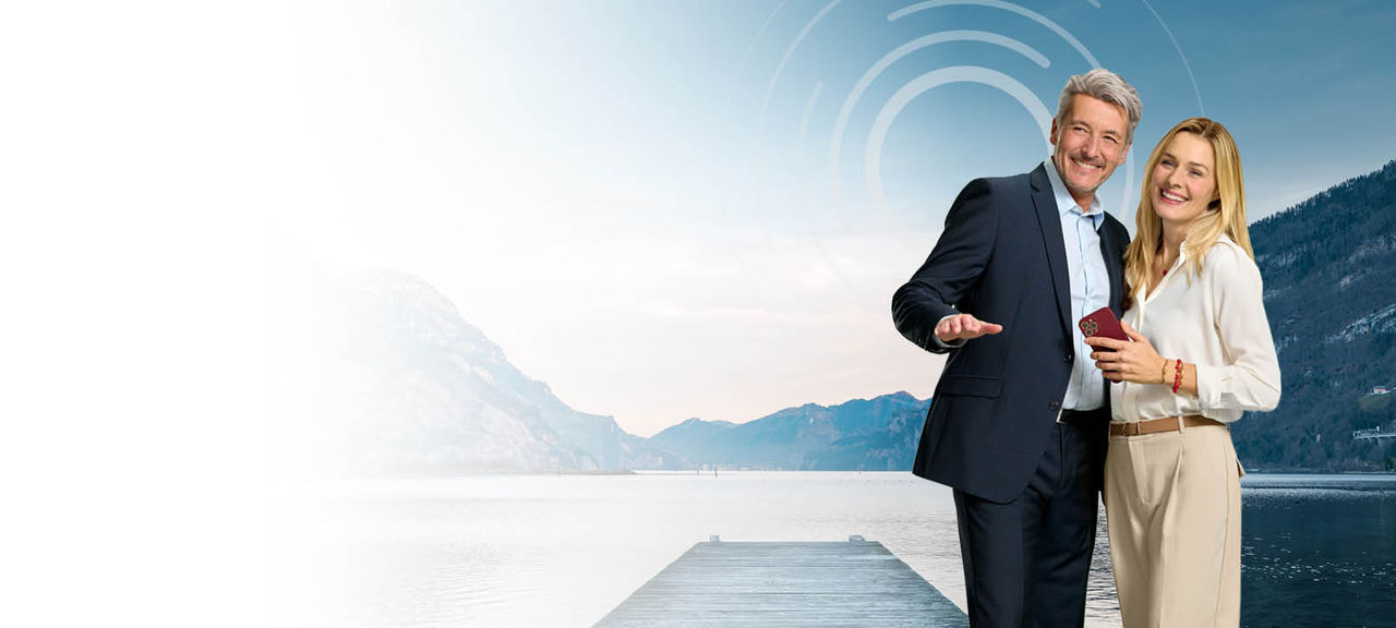 Couple in front of a like with a pier Couple in front of a like with a pier